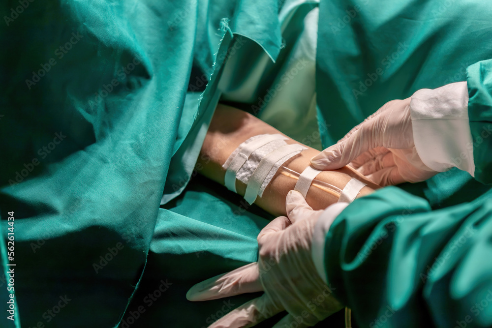 doctor putting medical tape tube patient for infusion operation. expert