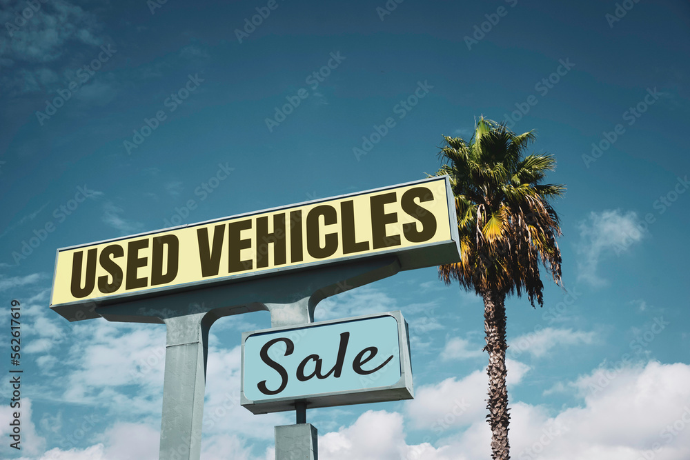 Fototapeta premium Aged and worn vintage used cars sign with palm tree