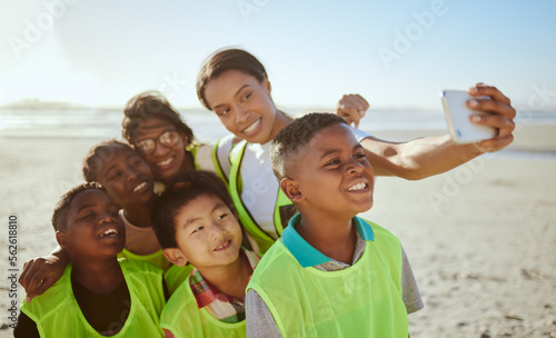 People, phone and selfie for eco friendly environment with smile at the beach for recycling in nature. Happy woman with kids smiling for photo by the sandy ocean looking at smartphone with vests