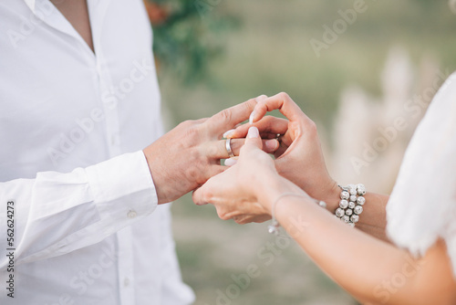Wedding rings. Putting on wedding rings. © Alisa