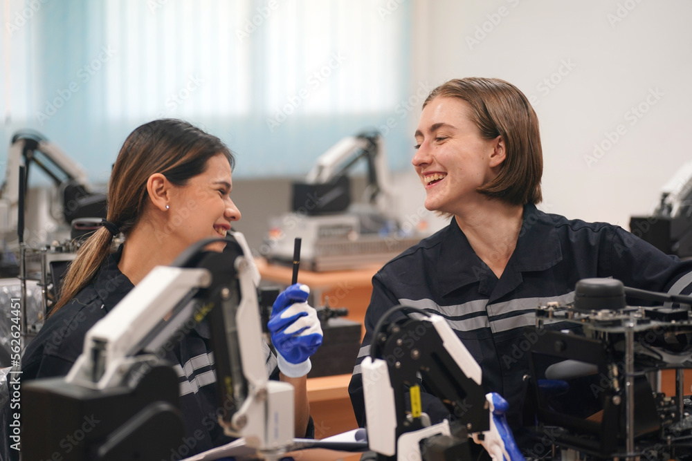 Engineer programming robot in robotics research facility Engineer programming robot in robotics research facility