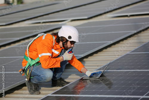 Professional worker installing solar panels on the roof. engineer working on checking equipment in solar power plant, Pure energy, Renewable energy. © FotoArtist