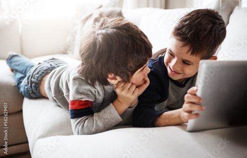 Kids, bonding or digital tablet for movie streaming, social media or esports gaming on family home sofa. Smile, happy or children brothers on technology for education video, learning support or help