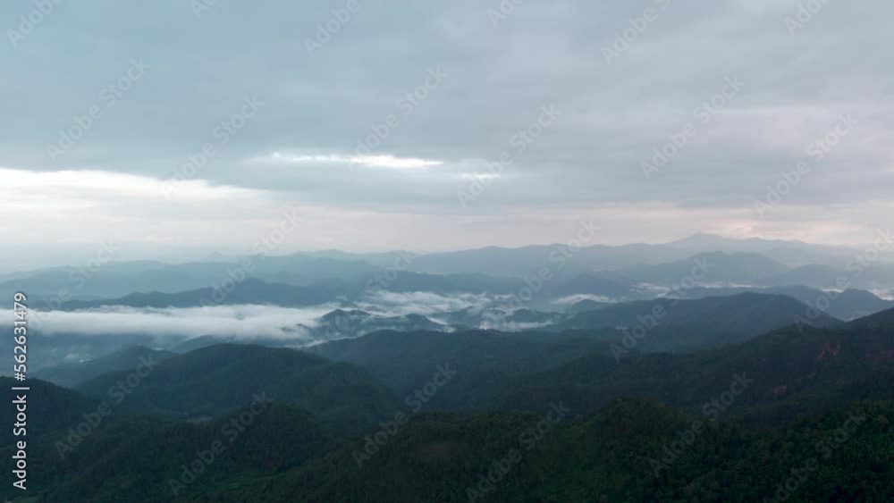 Top view Landscape of Morning Mist with Mountain Layer at north of Thailand. mountain ridge and clouds in rural jungle bush forest Top view Landscape of Morning Mist with Mountain Layer at north of Thailand. mountain ridge and clouds in rural jungle bush forest