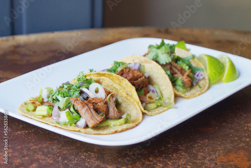 Pork tacos. A taco is a traditional Mexican food consisting of a small hand-sized corn tortilla