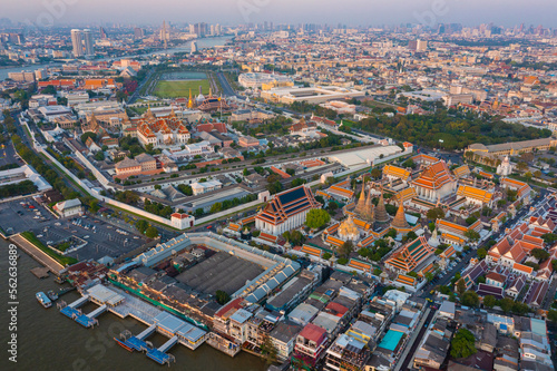 Aerial view Day to Night of Chao Phraya River with Royal Grand Palace and Emerald Buddha Temple Landmark of Bangkok, Thailand. Amazing Drone Footage over the City skyline in twilight.