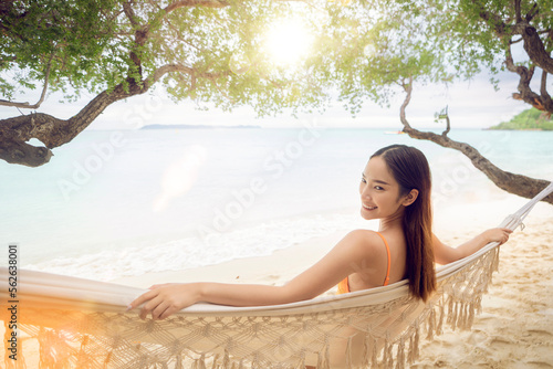 Obraz na płótnie Asian woman traveller sleep on the swing cragle with bikini on the beach at Pataya Beach, Thailand w salonie