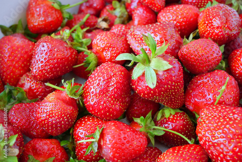 Fresh many tasty organic strawberries, strawberries with strawberry leaf, closeup, background