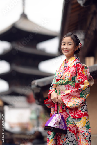 Asian traveler girl in Kimono traditional dress walking in old temple in Kyoto city