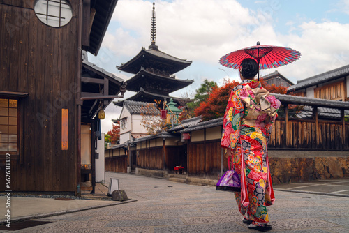 Asian traveler girl in Kimono traditional dress walking in old temple in Kyoto city