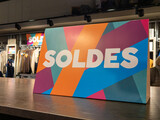 soldes french text means sale sign on shop shelf in clothing store on rack rack