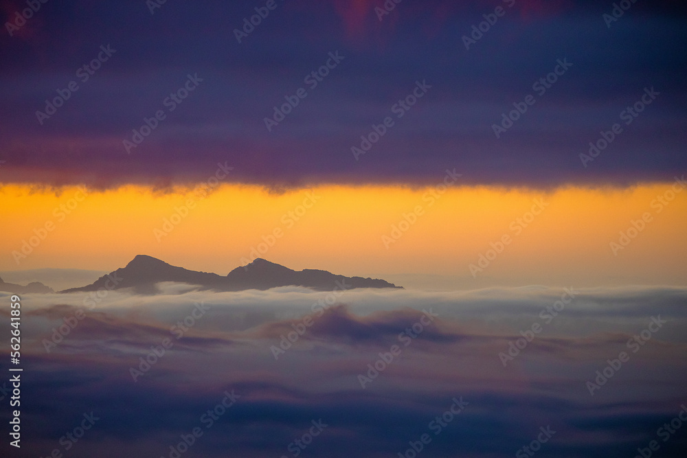 peaks above the clouds