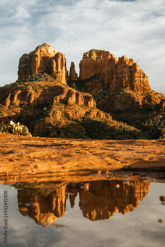 Red rock cathedral rock illuminated during sunset reflecting on small natural pool in the american southwest of Sedona Arizona after a heavy rain fall © ArboursAbroad.com