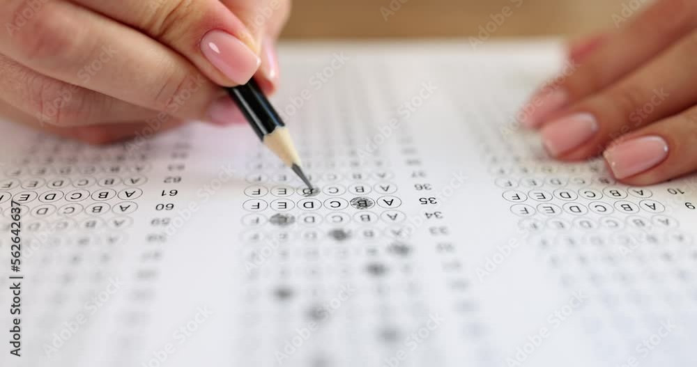 Student solving tests and crossing out correct answers with pencil on paper closeup 4k movie slow motion Student solving tests and crossing out correct answers with pencil on paper closeup 4k movie slow motion
