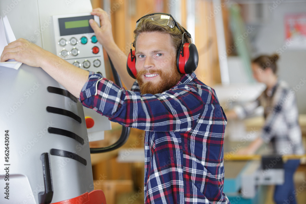 industrial worker operates a machine industrial worker operates a machine