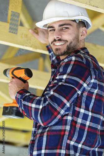 man builder drilling screws in ceiling