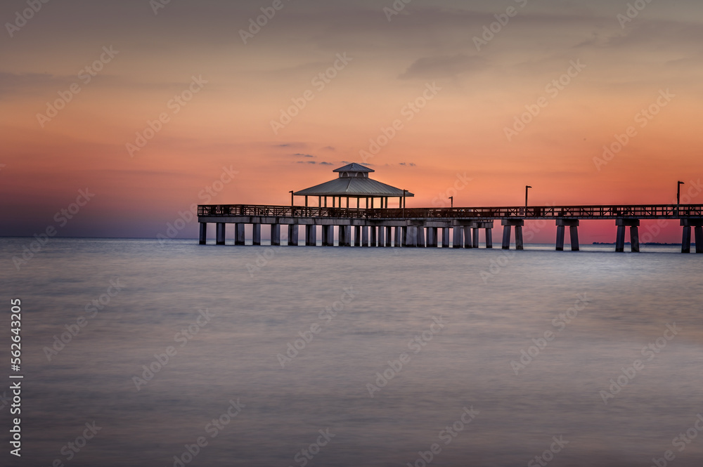 The wooden pier of Fort Myers beach at sunset, Florida The wooden pier of Fort Myers beach at sunset, Florida