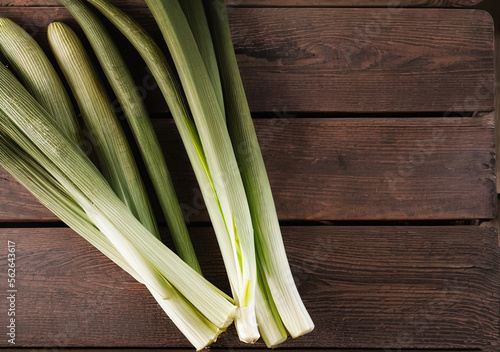 Food photo of a leeks on wooden table with copy space, Exotic Winter Fruit & Leeks and Green Onions Month - AI Generated