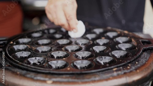 chef prepare the pan for cooking coconut rice pancake, kind of Thai sweetmeat, made from glutinous rice flour, sugar and coconut milk
