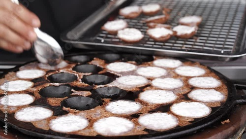 chef take coconut rice pancake out of the pan. coconut rice pancake is a kind of Thai sweetmeat, made from glutinous rice flour, sugar and coconut milk