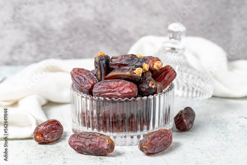 Date fruit on stone background. Organic Medjoul dates in a glass bowl. Ramadan food. close up photo