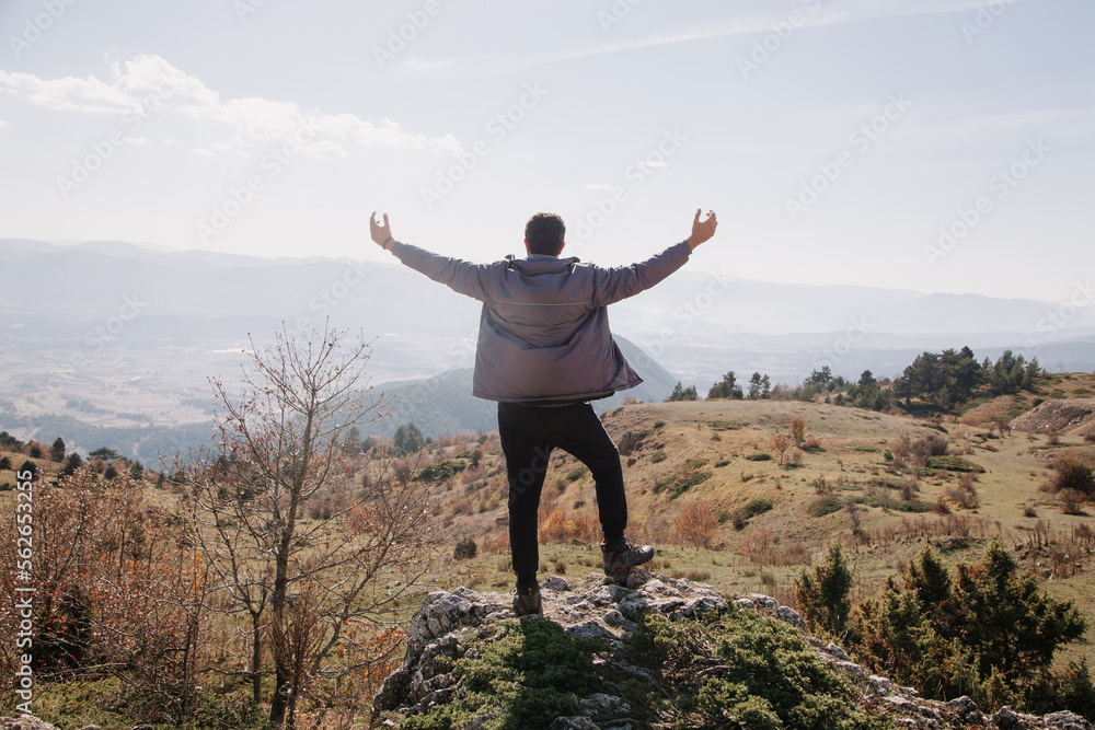 Hiking concept. Man having trekking in the mountains. Hiker on the rocks at sunny day in autumn. Hiking concept. Man having trekking in the mountains. Hiker on the rocks at sunny day in autumn.