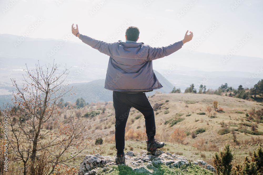 Hiking concept. Man having trekking in the mountains. Hiker on the rocks at sunny day in autumn. Hiking concept. Man having trekking in the mountains. Hiker on the rocks at sunny day in autumn.
