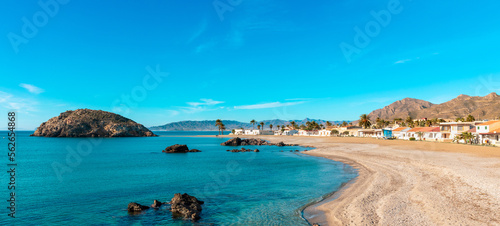 Fototapeta Naklejka Na Ścianę i Meble -  beautiful tropical beach with turquoise sea,  island and typical village ( Mazarron in Andalusia, Spain)