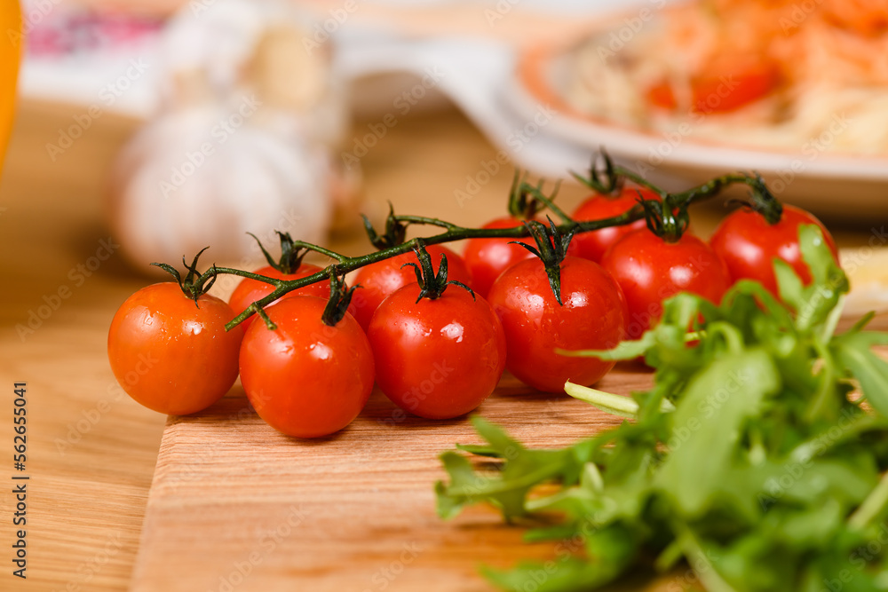 Sprig of cherry tomatoes on the table, close-up. Sprig of cherry tomatoes on the table, close-up.