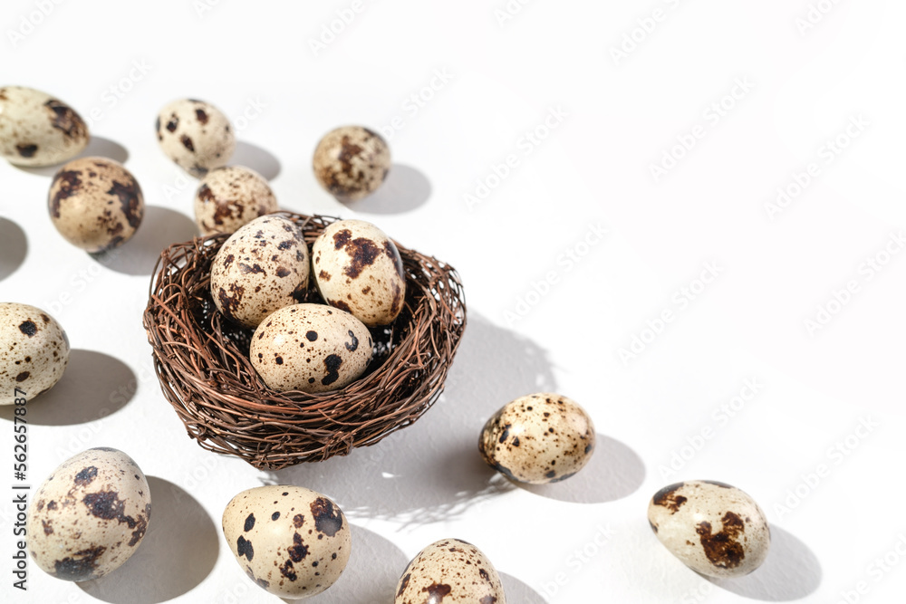 Quail eggs on a white background. Nest containing three egg. Minimal Easter concept. Natural farm products Quail eggs on a white background. Nest containing three egg. Minimal Easter concept. Natural farm products
