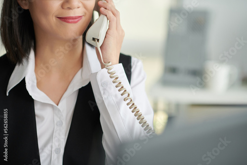 Smiling social worker, lawyer or businesswoman answering phone call