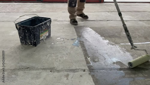 Construction works. 4k video footage with priming the floor surface before further finishing work
