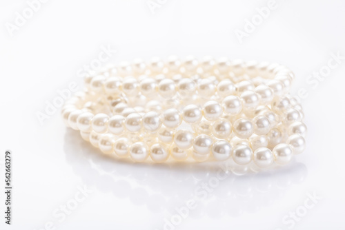 Pearl necklace on white background with copy space