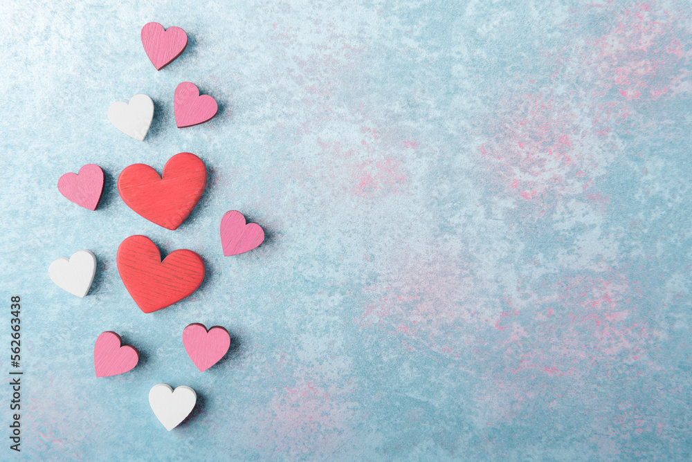 Fototapeta premium Valentine’s hearts on blue stone background with copy space. Valentines day greeting card template