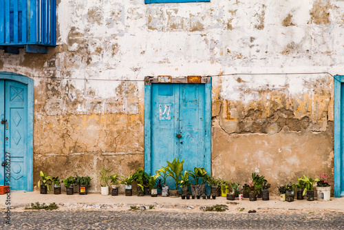 Colonial building with blue doors and old house wall in Sal Rei on Boa Vista island, Cape Verde