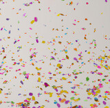 Close up of colorful confetti on white background created using Generative AI technology