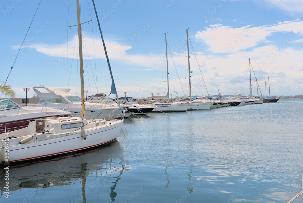 Fototapeta premium View on yacht club. White boats are in blue sea water.