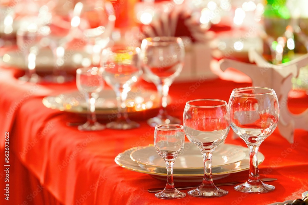 Crystal glasses for celebration, decorated for the holiday. Table setting. Crystal glasses for celebration, decorated for the holiday. Table setting.