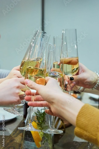 Connected glasses with champagne in their hands. Celebration of various events.