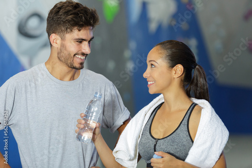 woman offering water to her sports companion