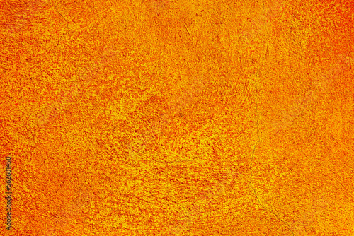 Orange, yellow abstract background, plaster texture, old painted facade of the building.