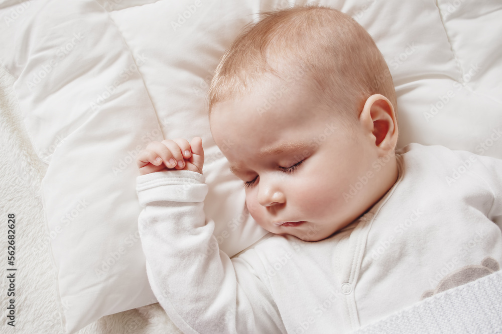 Cute five month old baby sleeping in comfortable bed. Cute five month old baby sleeping in comfortable bed.
