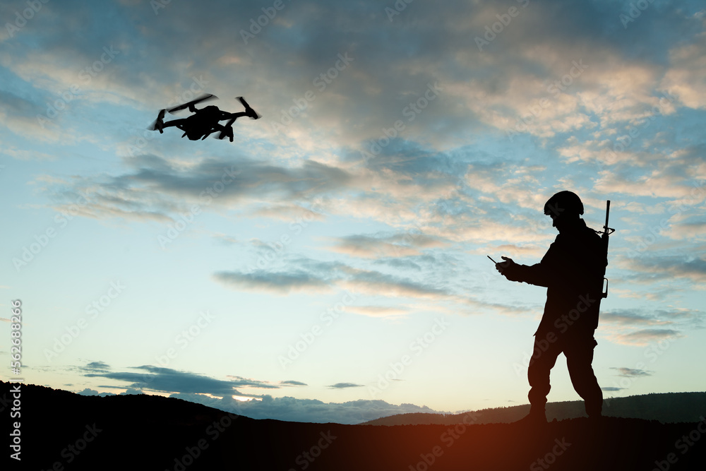 Silhouettes of soldiers are using drone and laptop computer for scouting during military operation against the backdrop of a sunset. Greeting card for Veterans Day, Memorial Day, Independence Day. Silhouettes of soldiers are using drone and laptop computer for scouting during military operation against the backdrop of a sunset. Greeting card for Veterans Day, Memorial Day, Independence Day.