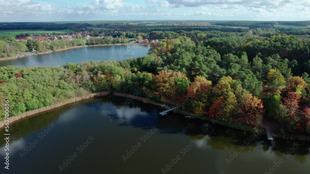 Aerial shot of beautiful lake surrounded by forest in a calm autumn day. Germany. 4K video. Aerial shot of beautiful lake surrounded by forest in a calm autumn day. Germany. 4K video.