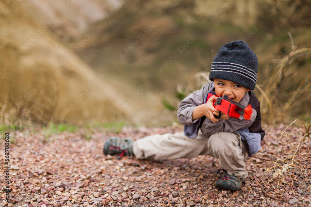 Boy wearing explorer costume holding toy rifle Boy wearing explorer costume holding toy rifle
