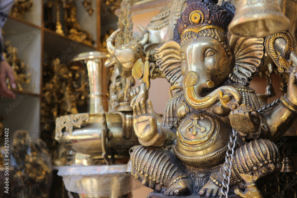 A large bronze Ganesha is sold in a shop.