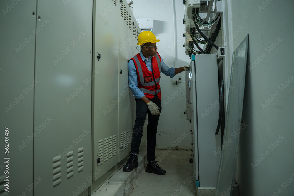Engineer working in electrical control room,operator station network in industry factory,Switchgear. Engineer working in electrical control room,operator station network in industry factory,Switchgear.