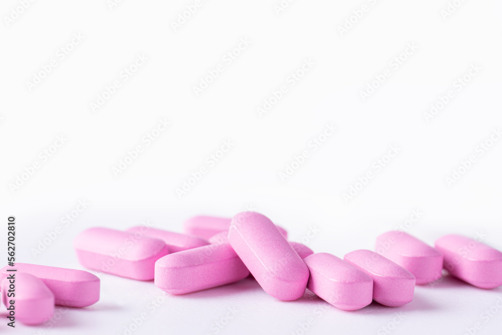Pink medicine pills on a white background Pink medicine pills on a white background