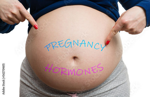 Close-up of future mother showing belly with pregnancy hormones text