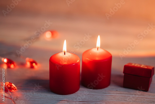 Beautiful composition with red candles on the white wooden table. Romantic love image